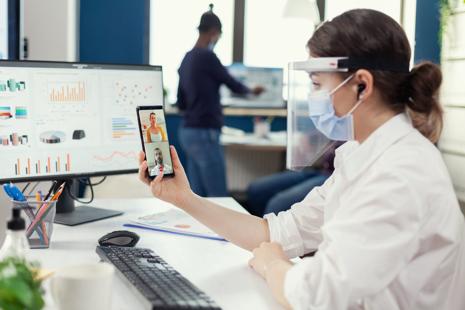 Businesswoman using wireless headphones during online conference