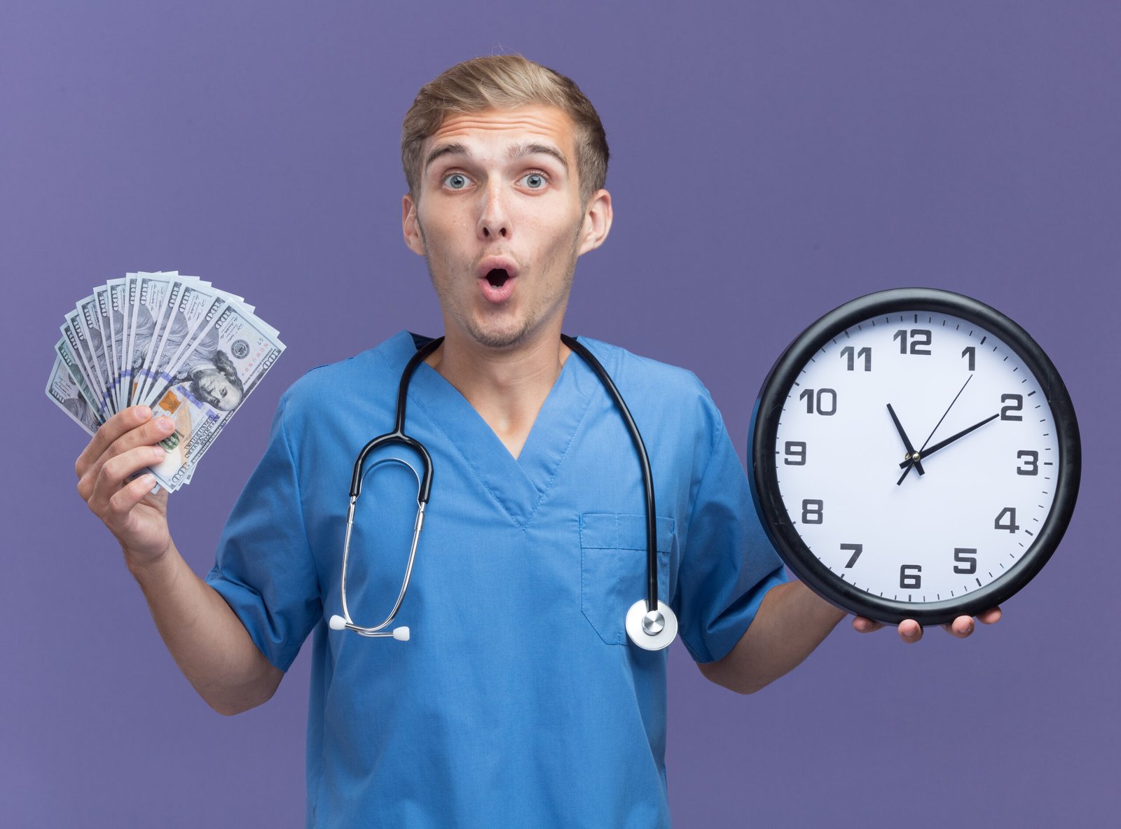 surprised young male doctor wearing doctor uniform with stethoscope holding wall clock with cash isolated on blue background